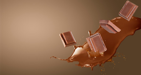 Close up of chocolate pieces falling on  white background