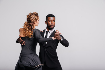 Couple dancers posing over white background. Dance school concept