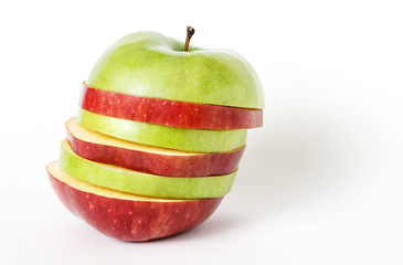 Sliced green and red apple. Isolated on white background. Pieces of apple collected like a pyramid.
