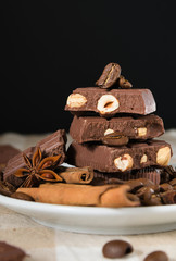 still life, installation, a plate with chocolate, coffee beans, anise and cinnamon sticks on a table