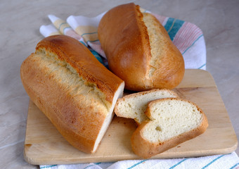 french roll on a board, white bread