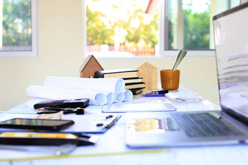 Desk of Architectural working project in construction site,With drawing equipment concept.