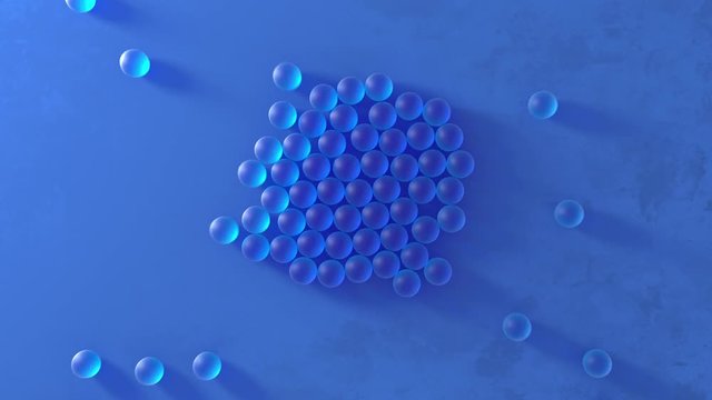 Transparent soft blue balls rolling in center on blue textured surface. Abstract 3D animation background with spheres rolling on surface. 4k.