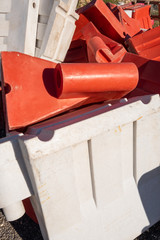 Red and white pieces of a road barrier