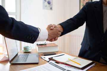 The lawyer shaking  hand agreement for consult preparing the phrase to be law for people who come to listen to counseling to receive social justice..concept of business
