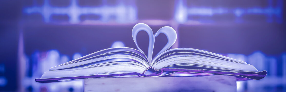 Stack of books in the library and blur bookshelf background	