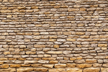 Stone wall texture background of stones stick together with clay.