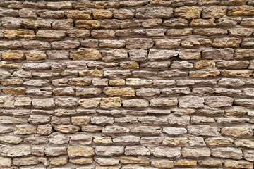 Stone wall texture background of stones stick together with clay.