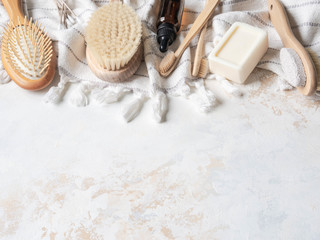Flat lay different body brushes, white cotton towel, pumice, bamboo toothbrush, aromatic oil and a piece of soap. Zero waste concept. Eco-friendly bath set. Top view