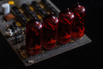 Nixie tubes on a printed circuit board with electronic components