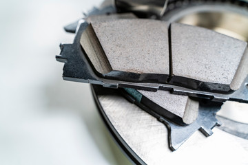 brake pads and auto parts on a white table