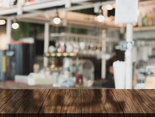 Wooden top table with bokeh light effect and blur restaurant on background