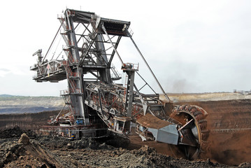 Fototapeta premium A huge bucket-wheel excavator digging coal on the open-pit mine. 