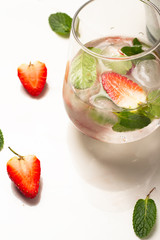 drink with ice, strawberries and mint on a white background
