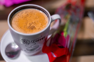Two cup of coffee with red rose. Couple on a date during valentine concept