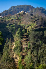 Fototapeta na wymiar zig-zag hiking trail in the hills. Uphill hike in Nepal.
