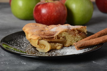 Homemade apple pie with sugar powder and cinnamon. Traditional American or English dessert 
