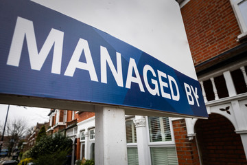 Obraz premium Property management company 'Managed by' sign board