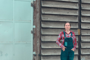 Portrait of female farmer in front of the farmhouse shed