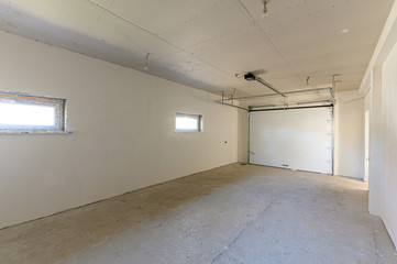 Russia, Moscow- September 10, 2019: interior room rough repair for self-finishing. interior decoration, bare walls of the room, stage of construction. bright modern car garage