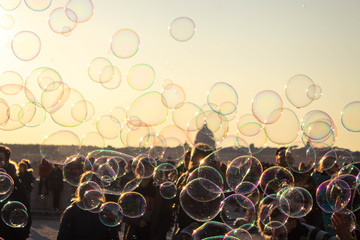 soap bubbles on the background of the sunset sky in Rome. kids catch soap bubbles - kids out of focus