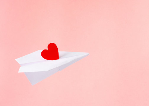 Paper Plane With Red Heart. Pink Background. Valentines Day Concept.