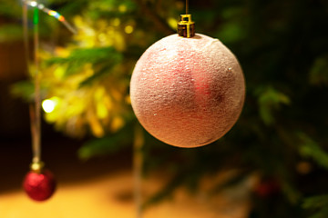 Christmas ball hanging on a branch close-up. with place for text