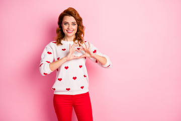 Portrait of her she nice attractive lovely lovable amorous cheerful cheery kind wavy-haired girl wearing white pullover showing heart sign isolated on pink pastel color background