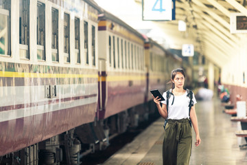 asian girl with backpack, travel by train, destination nature trip in summer