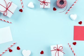 Valentine's Day, Mother's day art design concept for promotion - Red, white wrapped gift box isolated on pastel light blue color background, flat lay, top view.