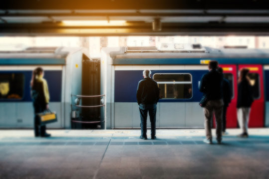 Blurry concept image of people travel by train on railway platform at  MTR train station in HongKong