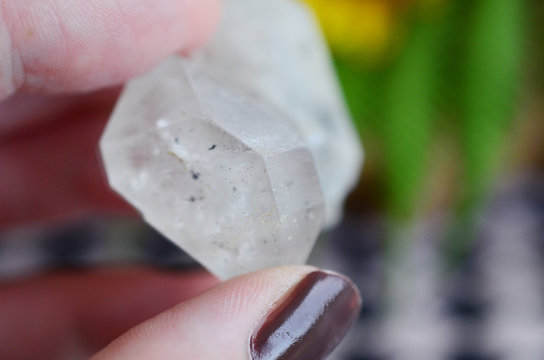 Woman holding clear quartz, beautiful healing crystal. Witches crystal healing, bright white crystal. Good energy, reiki healing. Bohemian, hipster crystal stone. Wiccan alternative alter. 