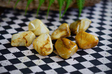 Large Tumbled Yellow Jasper! Creamy, yellow swirls. Beautiful intricate yellow jasper, great for detox and strength. Witches healing crystal. Vintage styled photo with lush colors, natural lighting. 