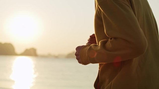 Handheld video shows of running man on the beach 