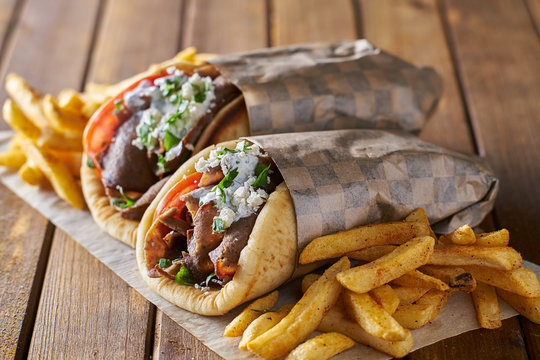 tasty greek gyros with fries with feta cheese and tzattziki sauce
