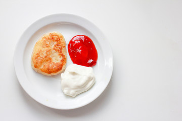 pancake, dough and jam on white saucer and on white background. Carnival concept.