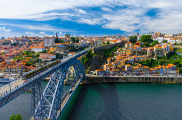 Fototapeta na wymiar Portugal Porto panorama, The Eiffel Bridge, Ponte Dom Luis, Bridge Ponti Di Don Luis, Douro river, panoramic view of Porto city, Porto in June, white clouds at summer blue sky in Porto