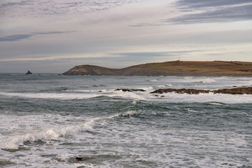 waves on a Cornish beach looking up to Trevose Head