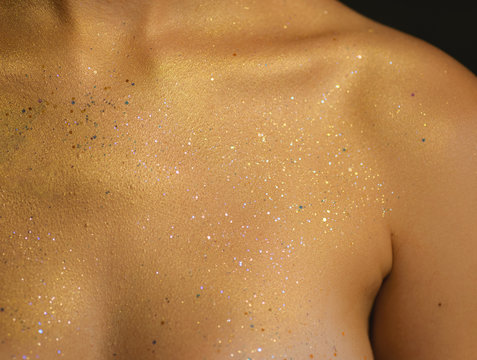 Closeup human skin with golden makeup. Selected focus with depth of field.
