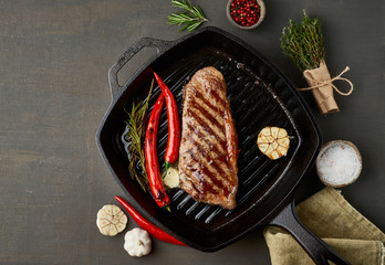 Keto ketogenic diet medium beef steak, fried striploin on grill pan. Paleo food recipe with meat,...