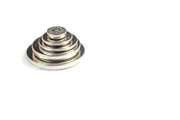 Heap of lithium button cell batteries. Closeup with shallow DOF.