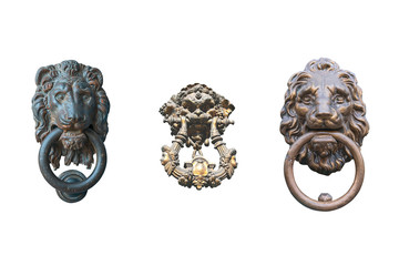 three old door handle in the form of a lion's head with a ring in his mouth isolated on a white...