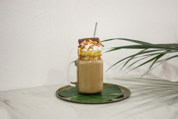 milkshake caramel, biscuit, whipped cream with metal straw