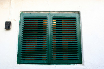 Fototapeta na wymiar Dark green wood windows with white wall