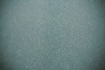 Gray textured wall, defocused interior background.