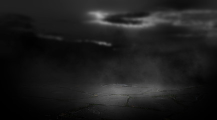 Fototapeta na wymiar Dramatic black and white background. Cloudy night sky, moonlight, reflection on the pavement. Smoke and fog on a dark street at night.