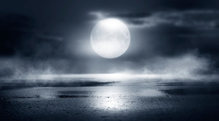 Dramatic black and white background. Cloudy night sky, moonlight, reflection on the pavement. Smoke...