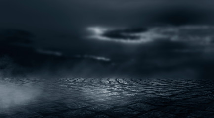 Dramatic black and white background. Cloudy night sky, moonlight, reflection on the pavement. Smoke and fog on a dark street at night.