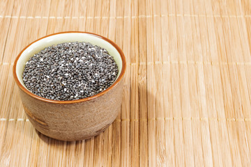 Chia seeds-ceramic bowl on a wooden background. Healthy diet. Healthy lifestyle.