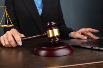 Woman lawyer reading legal book with wooden gavel on table in office. justice and law ,attorney,...